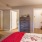 a bedroom with a bed dresser and a chair