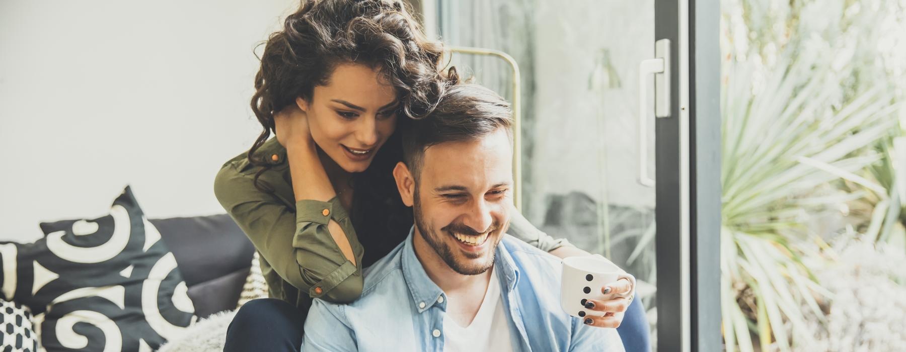 a man and a woman looking at a laptop