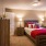 a bedroom with a bed and a mirror
